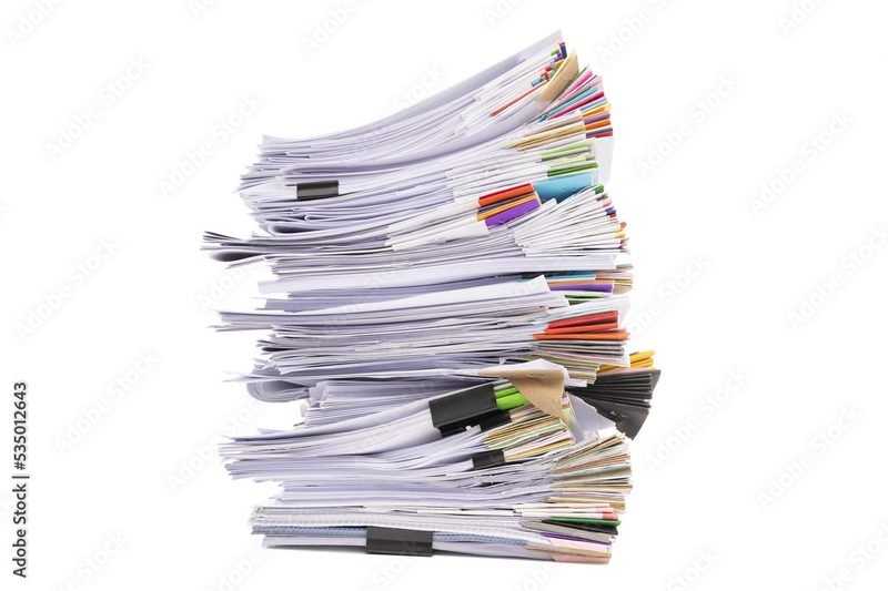 Tall stack of printed business documents with color tabs