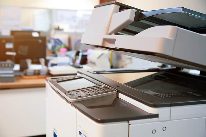 Multifunction office printer with automatic document feeder in a workplace
